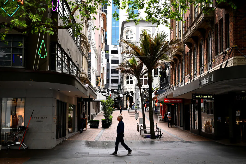 A man walks past shops during a COVID-19 lockdown on Queen Street in Auckland, New Zealand, on Nov. 22, 2021. (Hannah Peters/Getty Images)