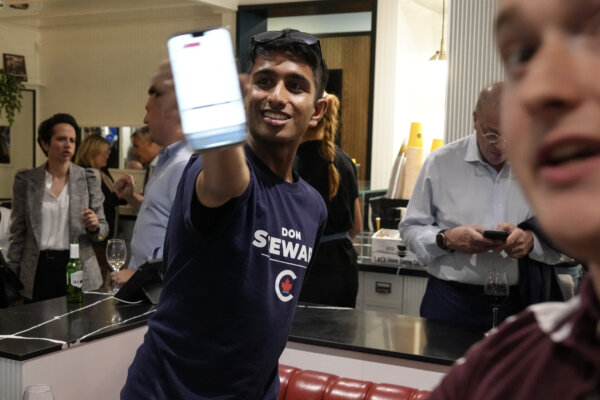 A Conservative supporter shows voting results on his phone at an Federal byelection election night event for Toronto-St.Paul Conservative candidate Don Stewart in Toronto, on June 24, 2024. (The Canadian Press/Chris Young)