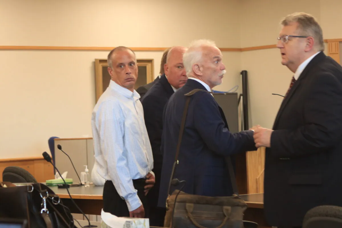 David Meehan (L), who was awarded $38 million by a jury for the sexual abuse he experienced as a boy at a New Hampshire youth detention center, is surrounded by his lawyers at a hearing at Rockingham County Superior Court in Brentwood, N.H., on June 24, 2024. (Alice Giordano/The Epoch Times)