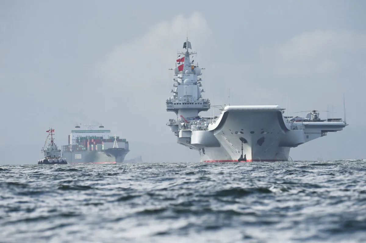 China's aircraft carrier, the Liaoning (R), arrives in Hong Kong waters on July 7, 2017. (Anthony Wallace/AFP via Getty Images)