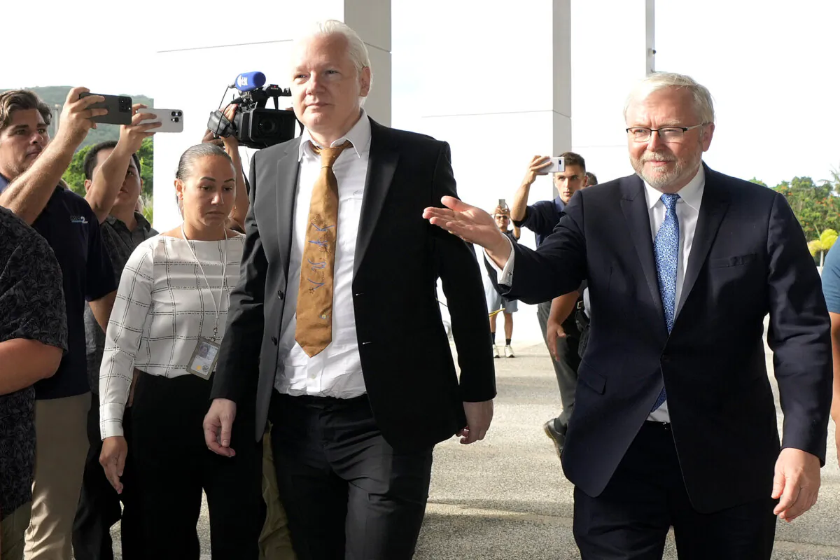 WikiLeaks founder Julian Assange (C) arrives at the United States courthouse where he is expected enter a plea deal in Saipan, Mariana Islands, on June 26, 2024. (Eugene Hoshiko/AP Photo)