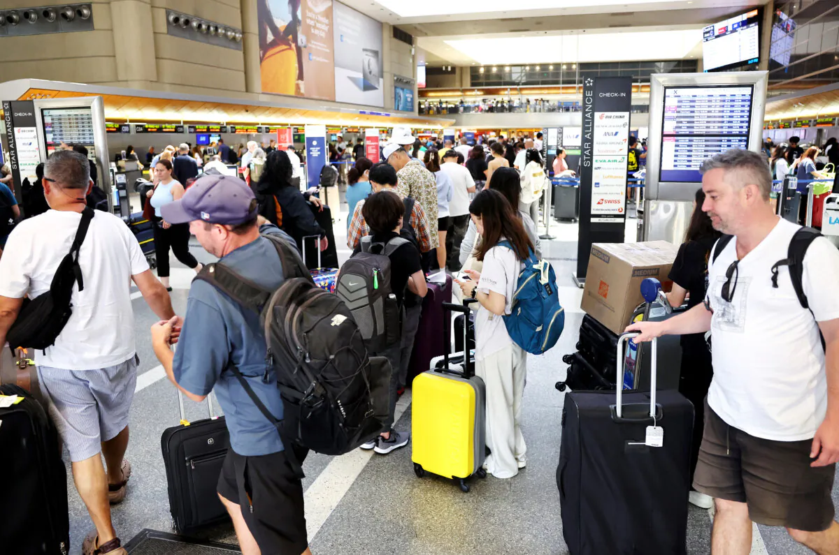 Travelers gather with their luggage in the international terminal at Los Angeles International Airport (LAX) on June 25, 2024.(Photo by Mario Tama/Getty Images)