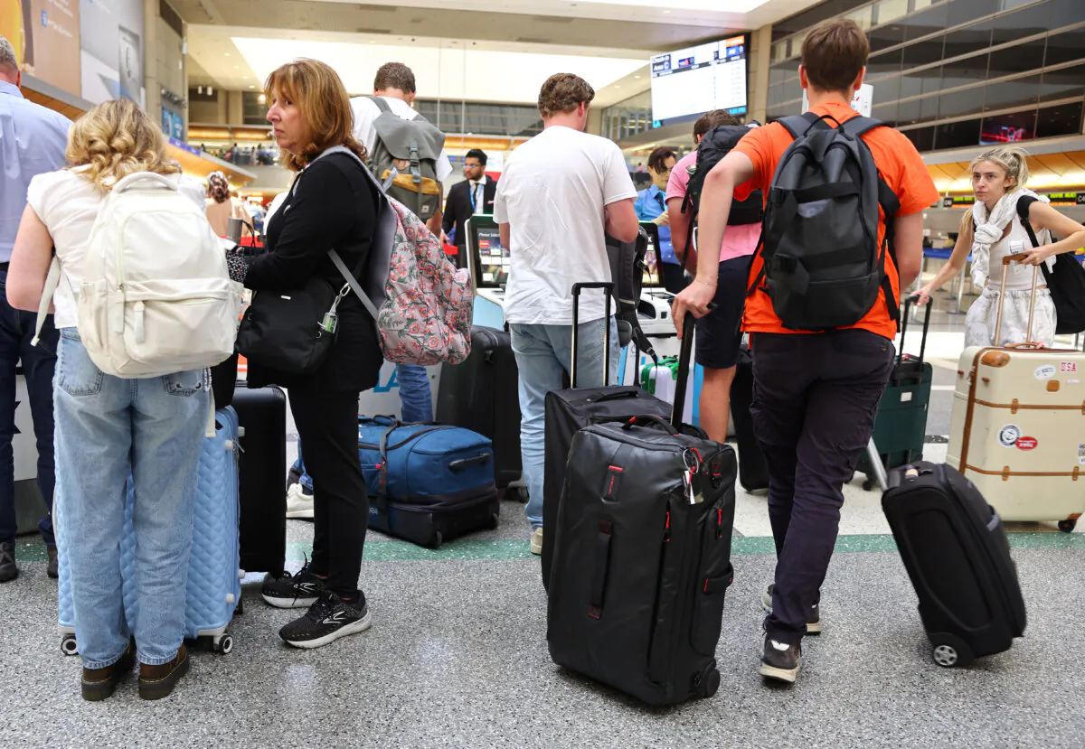 Travelers gather with their luggage in the international terminal at LAX, in Los Angeles, Calif., on June 25, 2024. (Mario Tama/Getty Images)