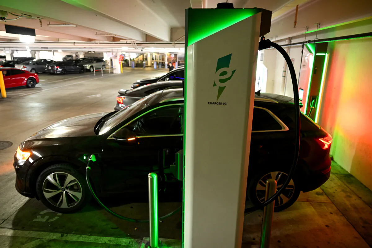 An electric Audi sports utility vehicle (SUV) charges at a public Electrify America EV DC fast charger in Los Angeles, California on May 16, 2024. (Patrick T. Fallon/AFP)