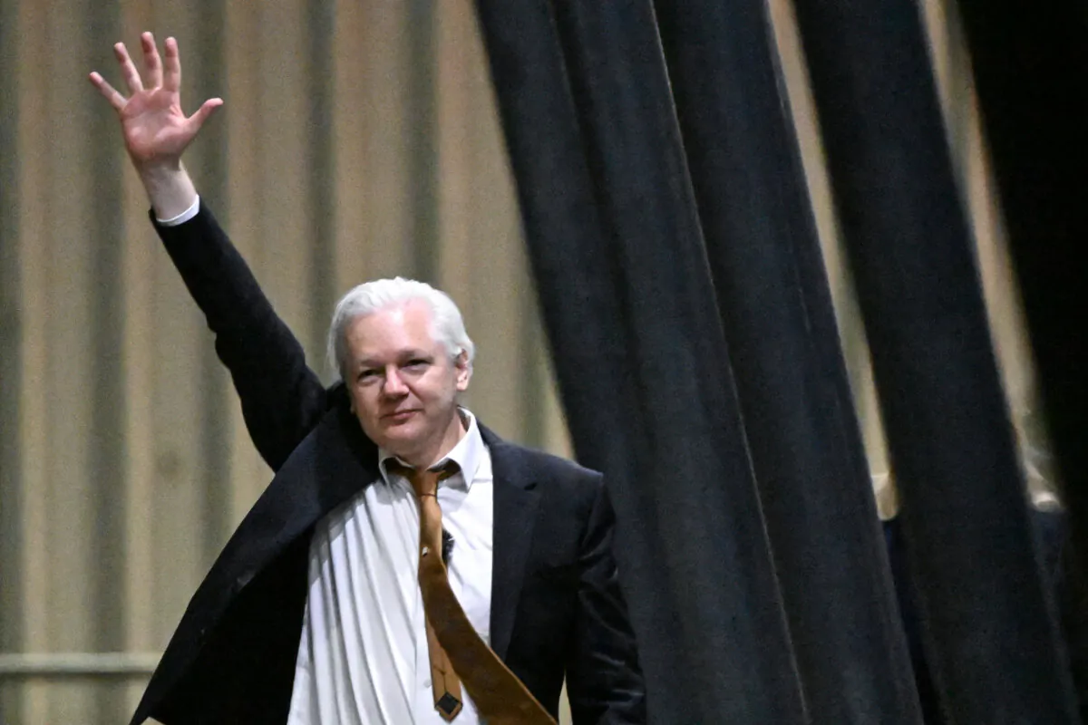 WikiLeaks founder Julian Assange waves after arriving at Canberra Airport in Canberra, Australia on June 26, 2024. (William West/AFP via Getty Images)