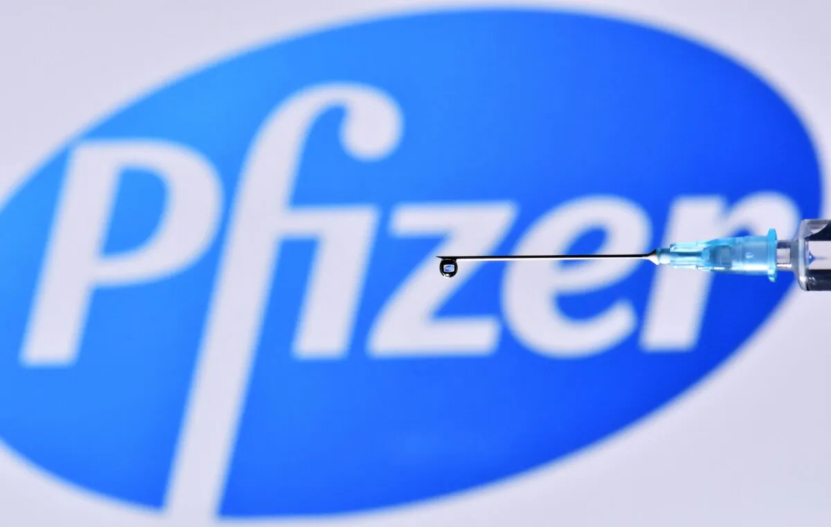 A logo of US pharmaceutical giant Pfizer and a close up of a needle, dated Nov. 17, 2020. (Justin Tallis/AFP via Getty Images)