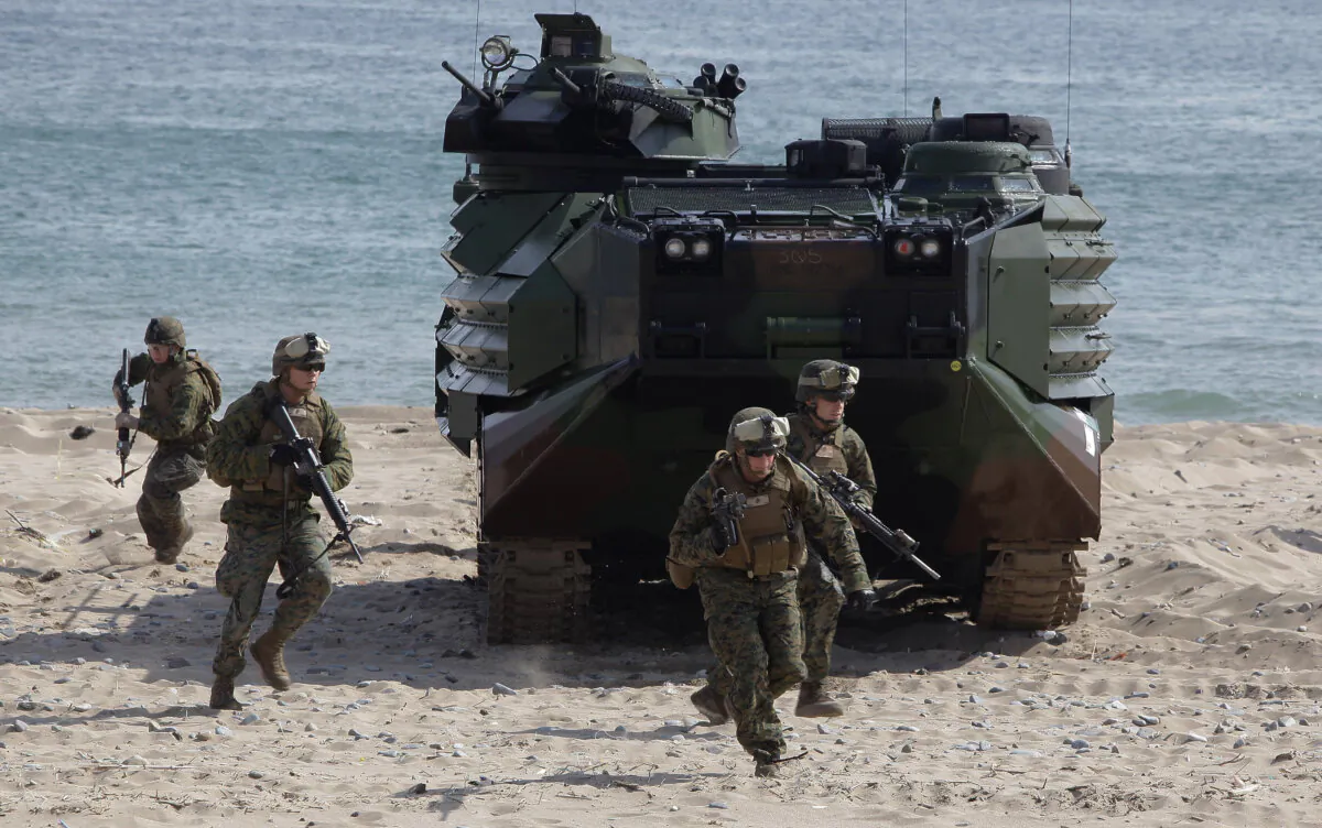 U.S. Marines from the 31st Marine Expeditionary Unit, Battalion landing team deployed from Okinawa, Japan, exit an Amphibious Assault Vehicle (AAV) during the U.S. and South Korean Marines joint landing operation at Pohang seashore, in Pohang, South Korea, on March 29, 2012. (Chung Sung-jun/Getty Images)