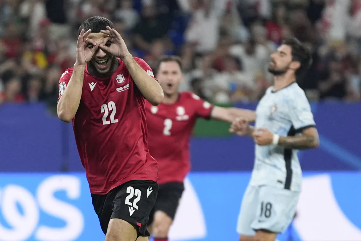 Georgia's Georges Mikautadze celebrates after scoring on a penalty kick during a Group F match between Georgia and Portugal at the Euro 2024 soccer tournament in Gelsenkirchen, Germany, on June 26, 2024. (Martin Meissner/AP Photo)