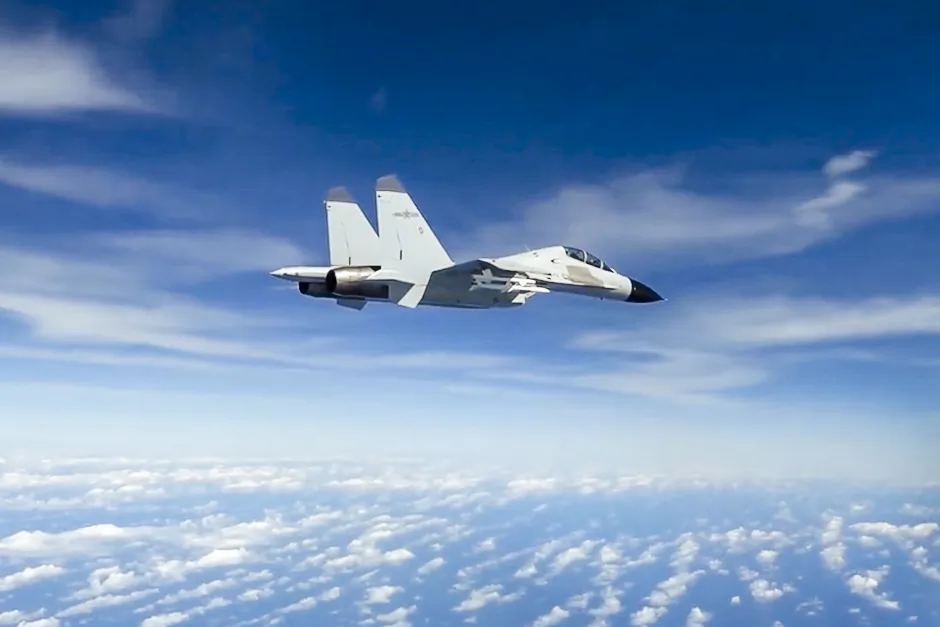 A Chinese People’s Liberation Army Navy J-11 fighter pilot performs an unsafe maneuver during an intercept of a U.S. Air Force RC-135 aircraft, which was lawfully conducting routine operations over the South China Sea in international airspace, on Dec. 21, 2022, in a still from video. (Courtesy of U.S. Indo-Pacific Command/Screenshot via The Epoch Times)