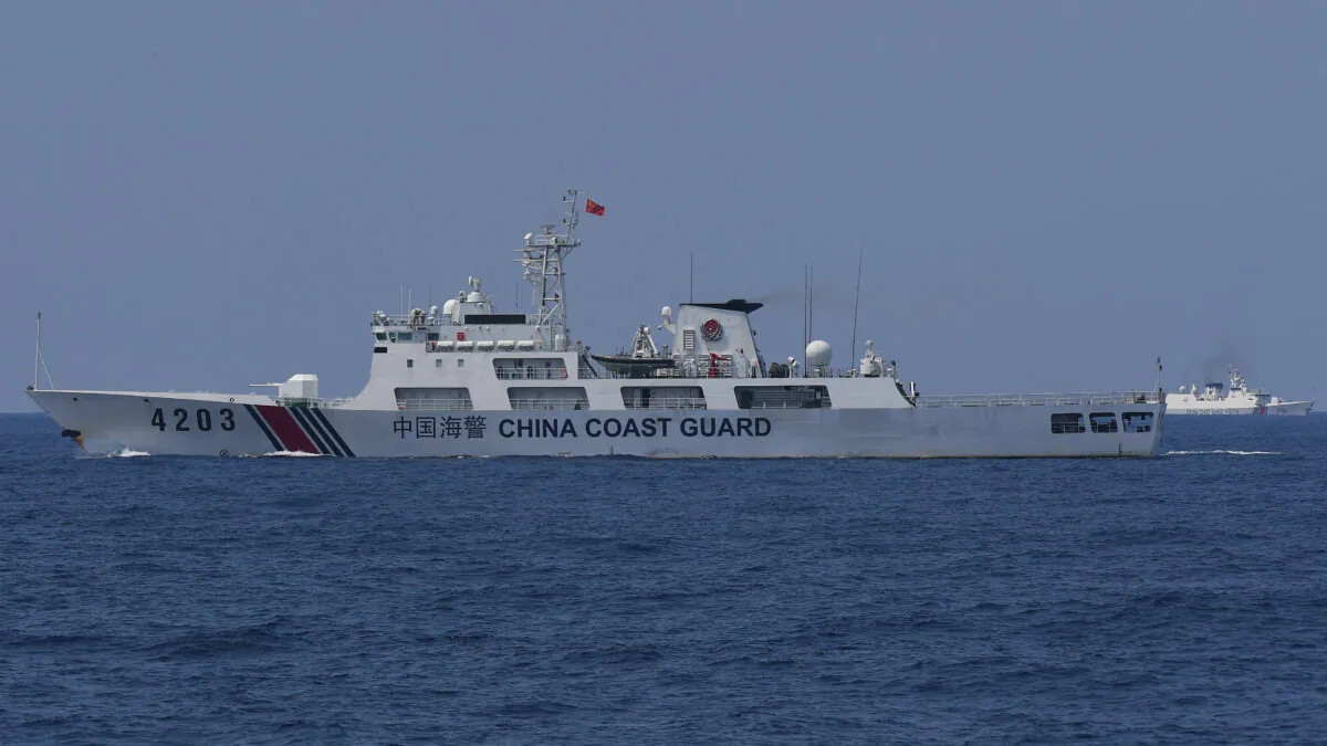China Coast Guard ships monitor the distribution of fuel and food to fishers by the civilian-led mission Atin Ito (This Is Ours) Coalition, in the disputed South China Sea on May 16, 2024. (Ted Aljibe/AFP via Getty Images)