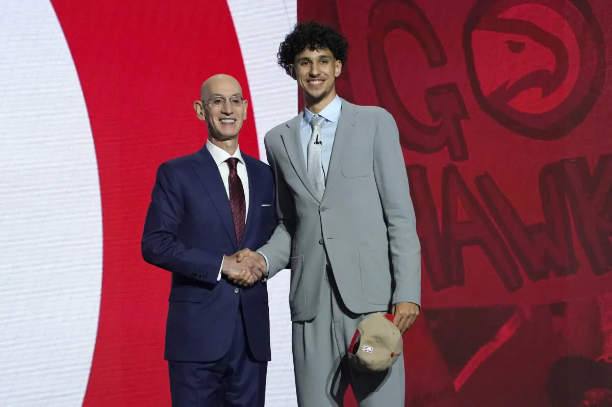 French basketball player Zaccharie Risacher (R) poses with Adam Silver, Commissioner of the NBA during Round One of the NBA's annual draft in Brooklyn on June 26, 2024. (Timothy A. Clary/ AFP)