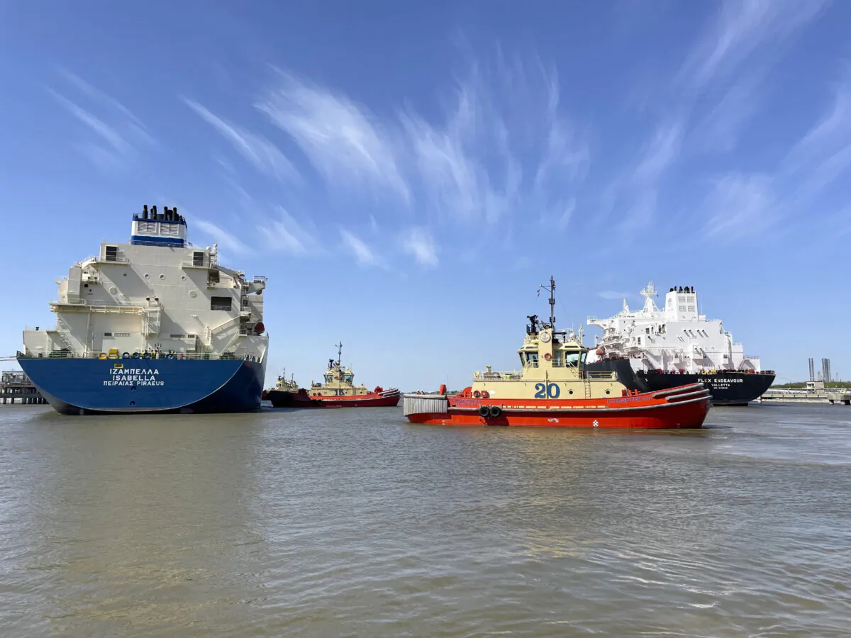 A liquefied natural gas tanker is guided by tugboats at the Cheniere Sabine Pass LNG export unit in Cameron Parish, La., on April 14, 2022. (Marcy de Luna/Reuters)