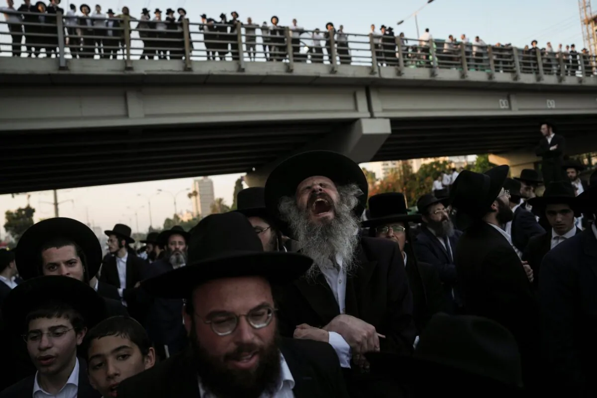 Ultra-Orthodox Jewish men block a highway during a protest against army recruitment in Bnei Brak, Israel, on June 27, 2024. (Oded Balilty/AP Photo)