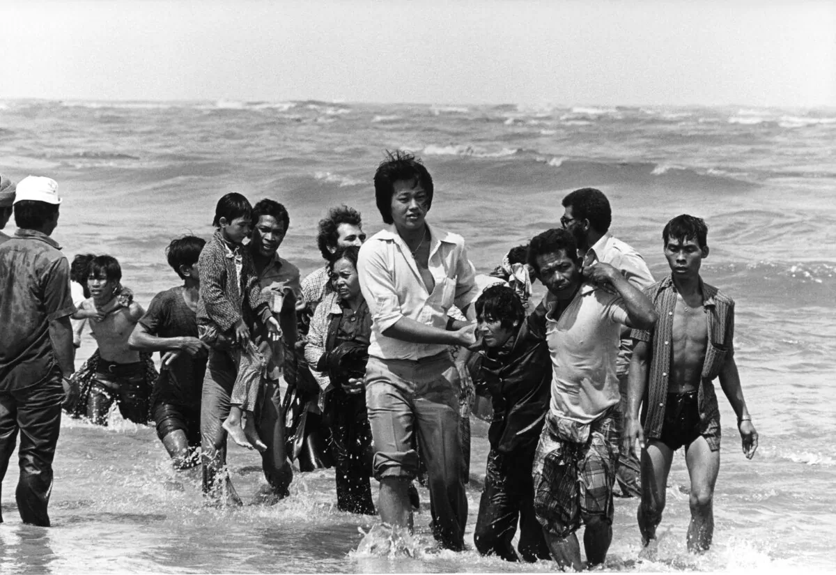 A group refugees whose small boat sank wade to shore in Malaysia in the late 1970s. Almost 200,000 Vietnamese “boat people” fleeing communism found refuge and freedom in Canada. (K. Gaugler/UNHCR/AFP via Getty Images)