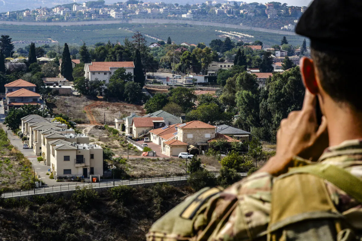 A Lebanese soldier monitors the border area of the northern Israeli town of Metula on Oct. 8, 2023. (Mahmoud Zayyat/AFP via Getty Images)