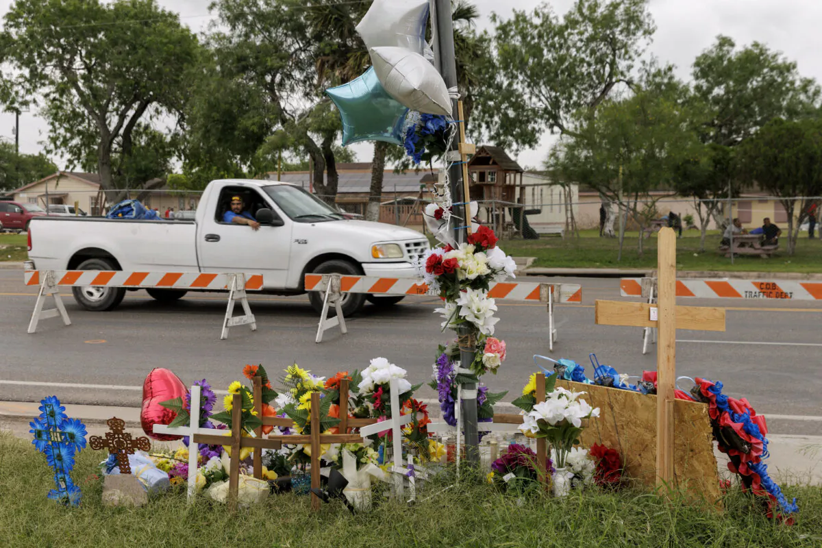 A passenger looks at a memorial site from a moving vehicle where eight migrants were killed, and several others injured the day before while waiting at a bus stop in Brownsville, Texas, on May 8, 2023. (Michael Gonzalez/AP Photo, File)
