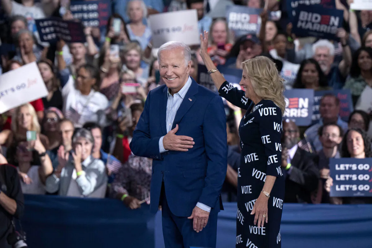 President Joe Biden (L) and First Lady Jill Biden (R), with "VOTE" printed on her dress, gesture to supporters at a post-debate campaign rally in Raleigh, N.C., on June 28, 2024. (Allison Joyce/Getty Images)