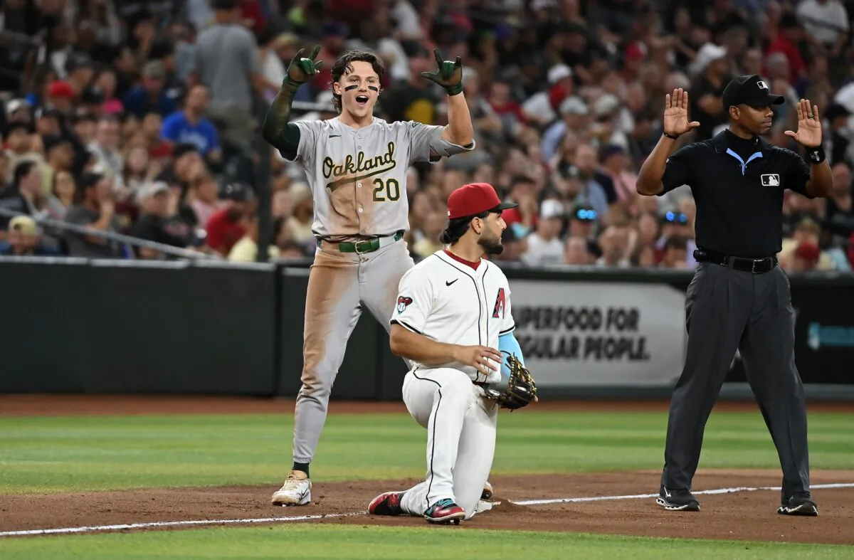 Zack Gelof (20) of the Oakland Athletics gestures to his dugout after hitting an RBI triple against the Arizona Diamondbacks during the eighth inning in Phoenix on June 28, 2024. (Norm Hall/Getty Images)