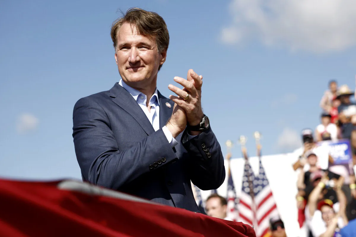 Virginia Gov. Glenn Youngkin listens as Republican presidential candidate, former President Donald Trump speaks during a rally at Greenbrier Farms in Chesapeake, Va., on June 28, 2024. (Anna Moneymaker/Getty Images)