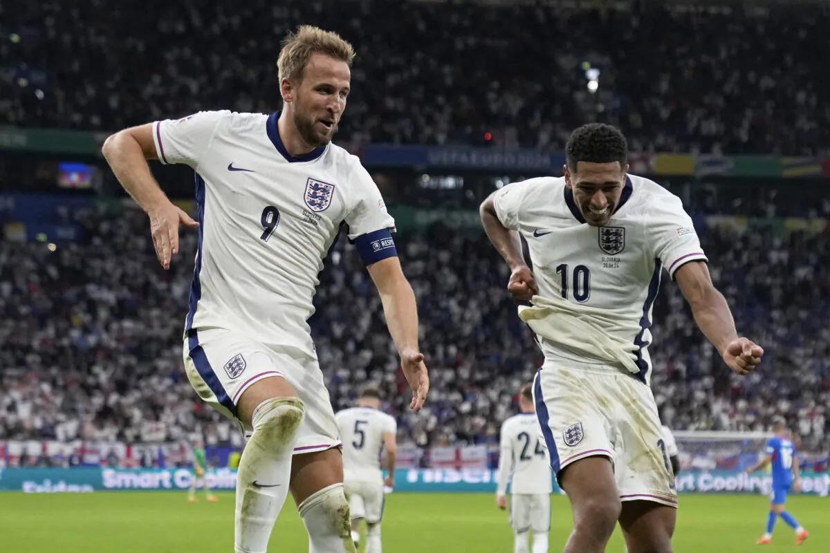 England's Harry Kane (L) celebrates with Jude Bellingham after scoring his side's second goal during a round of sixteen match between England and Slovakia at the Euro 2024 soccer tournament in Gelsenkirchen, Germany, on June 30, 2024. (Thanassis Stavrakis/AP Photo)