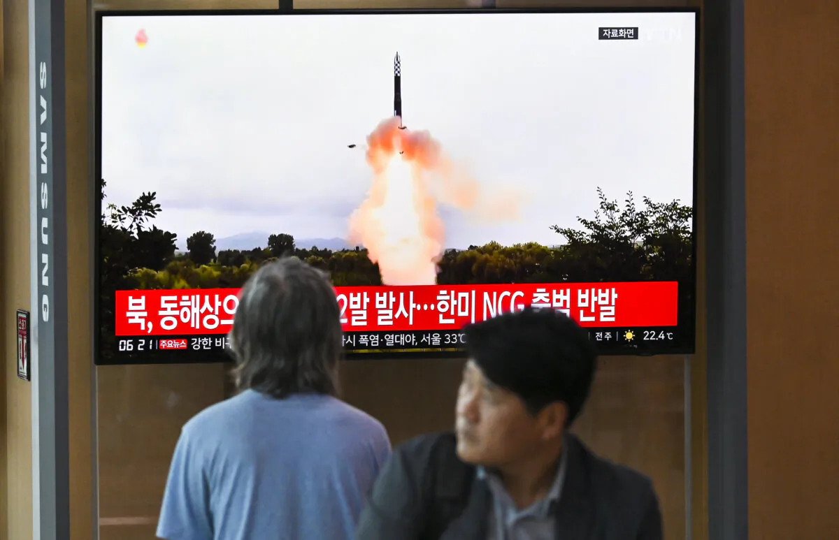 People watch a television screen showing a news broadcast with file footage of a North Korean missile test, at a railway station in Seoul, South Korea, on July 19, 2023. (Jung Yeon-je/AFP via Getty Images)