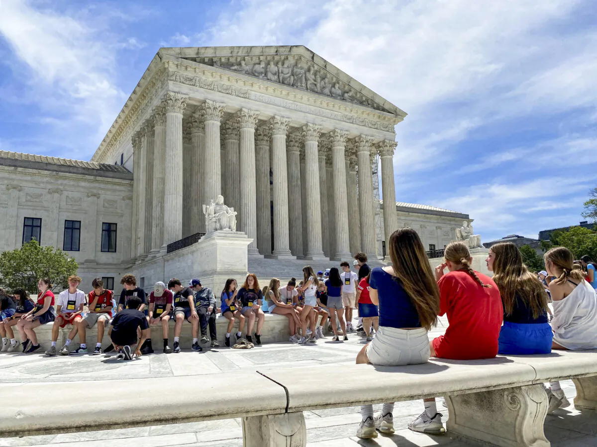 A general view of the U.S. Supreme Court building, with members of a student group in the foreground, in Washington, on June 1, 2024. (Will Dunham/REUTERS)