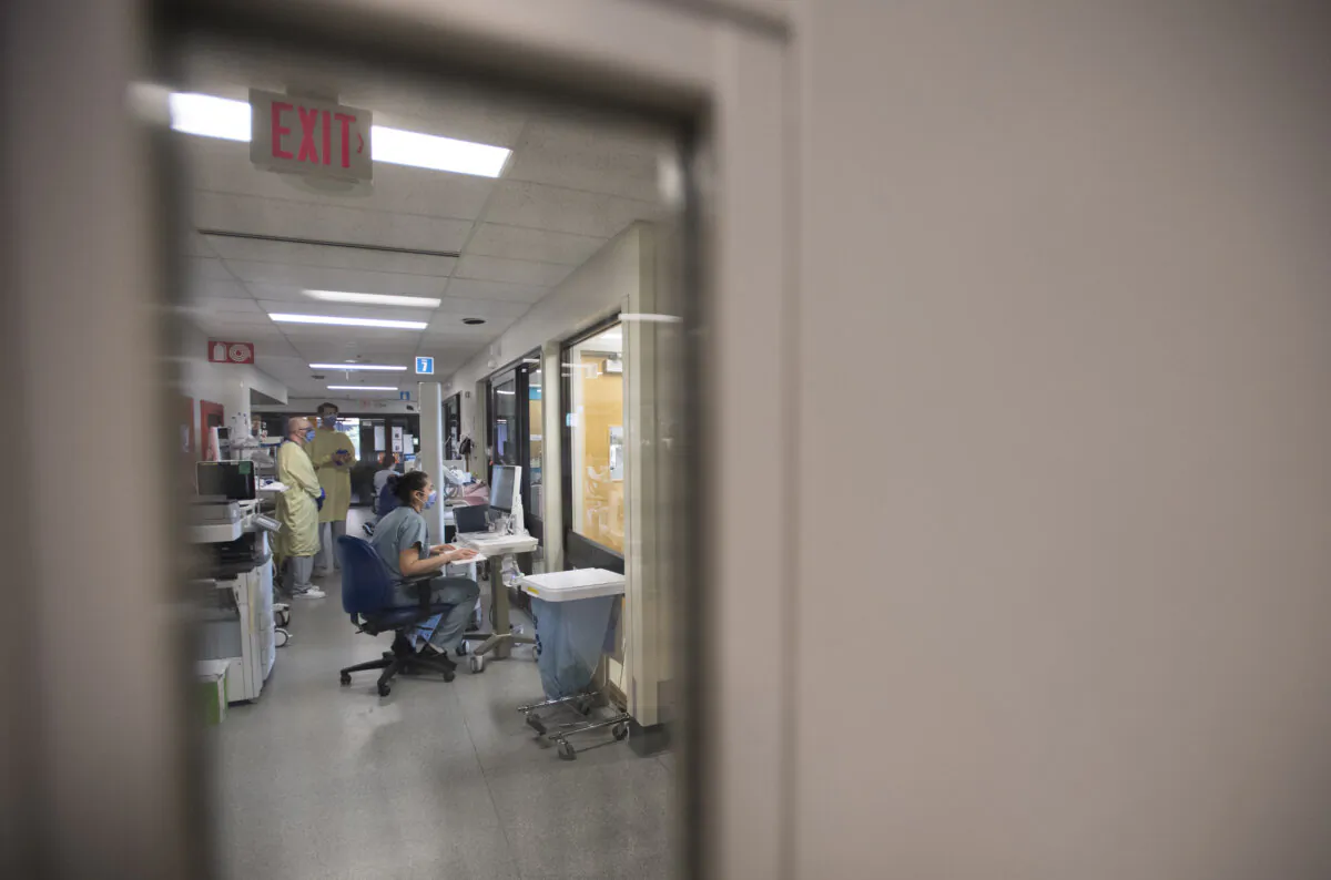 A nurse monitors a patient from outside his room in the COVID-19 intensive care unit at St. Paul's hospital in downtown Vancouver on April 21, 2020. (The Canadian Press/Jonathan Hayward)