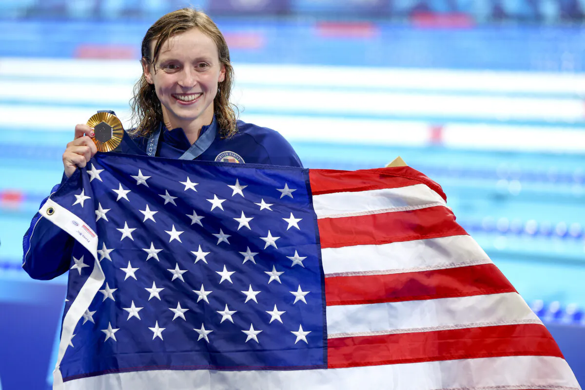 Gold medalist Katie Ledecky of Team USA poses with the U.S. flag following the medal ceremony for the Women's 1500m Freestyle on day five of the Olympic Games, in Nanterre, France, on July 31, 2024. (Maddie Meyer/Getty Images)