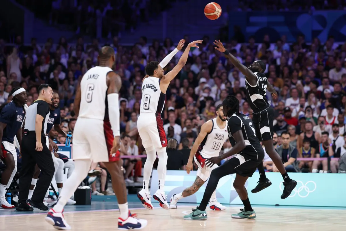 Tyrese Haliburton (9) of Team United States shoots over Marial Shayok (11) of Team South Sudan during a Men's Group Phase—Group C game between the United States and South Sudan on day five of the Olympic Games Paris 2024 in Lille, France, on July 31, 2024. (Gregory Shamus/Getty Images)