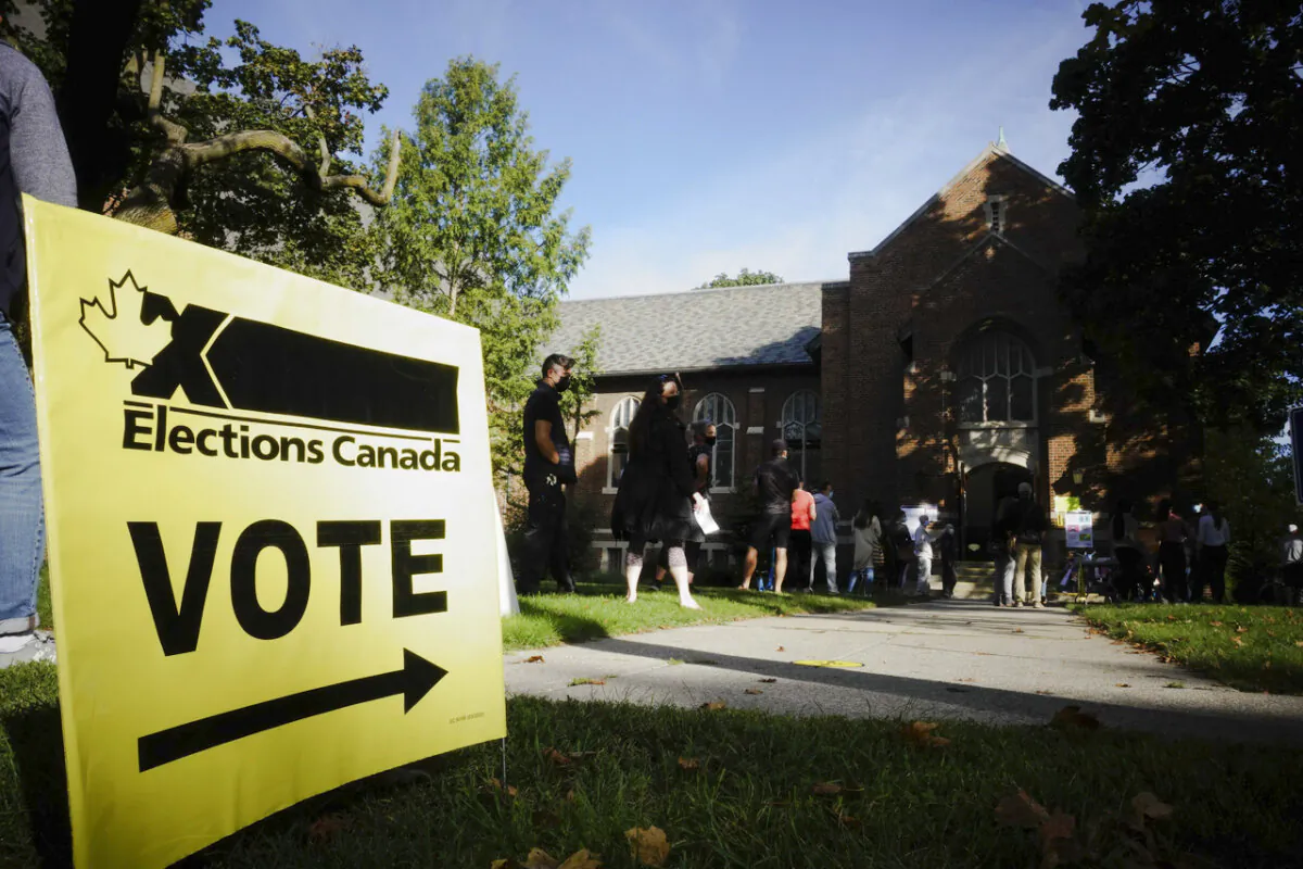 People start to line up early for the Canadian general election before polls open in west-end Toronto for the Sept. 20, 2021. (The Canadian Press/Graeme Roy)
