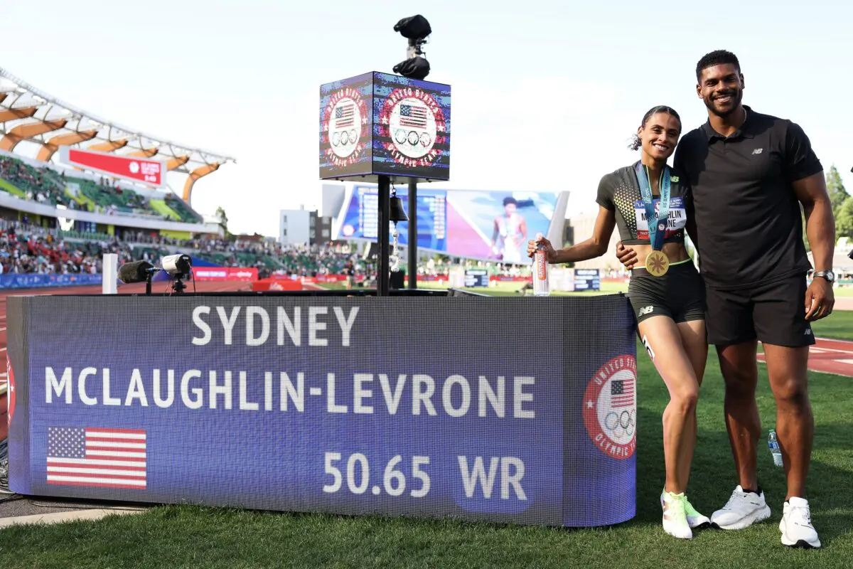 Gold medalist Sydney McLaughlin-Levrone and Andre Levrone pose with her new world record in the women's 400 meter hurdles final on Day Ten of the 2024 U.S. Olympic Team Track & Field Trials in Eugene, Oregon on June 30, 2024.. (Patrick Smith/Getty Images)