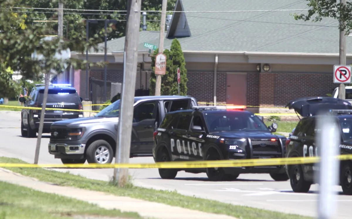 Police secure the scene where two police officers were wounded and a suspect was killed in an exchange of gunfire in Waterloo, Iowa, on June 30, 2024. (Jeff Reinitz/The Courier via AP)