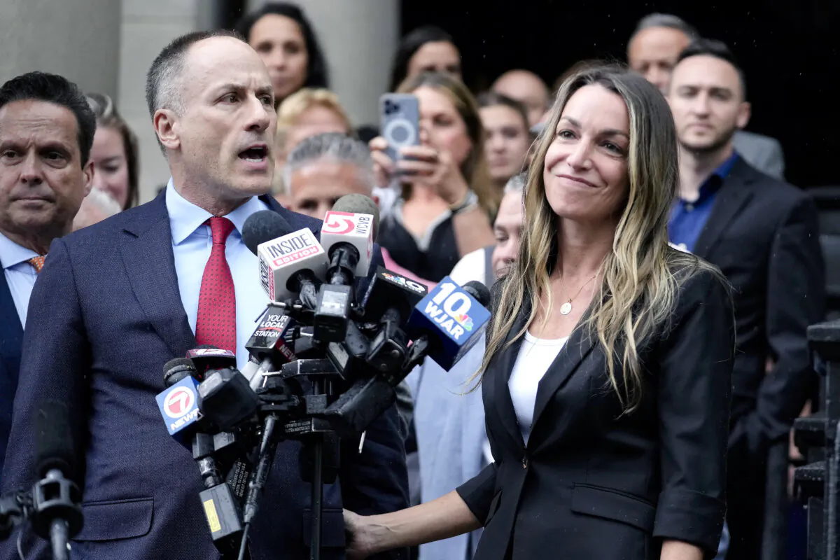 Karen Read (R) listens as defense attorney David Yannetti speaks to reporters in front of Norfolk Superior Court in Dedham, Mass. after the judge declared a mistrial on July 1, 2024. (Steven Senne/AP)
