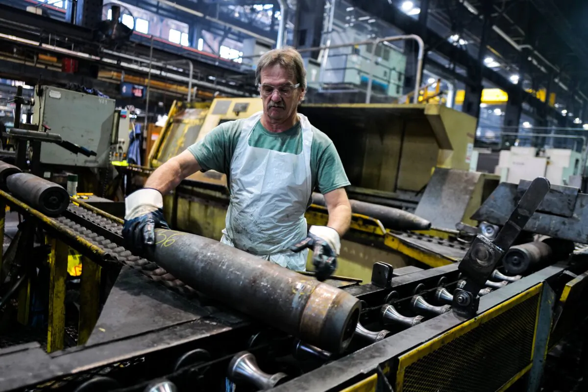 A worker handles 155 mm calibre shells after the manufacturing process at the Scranton Army Ammunition Plant in Scranton, Pa., on April 16, 2024. (Charly Triballeau/AFP via Getty Images)