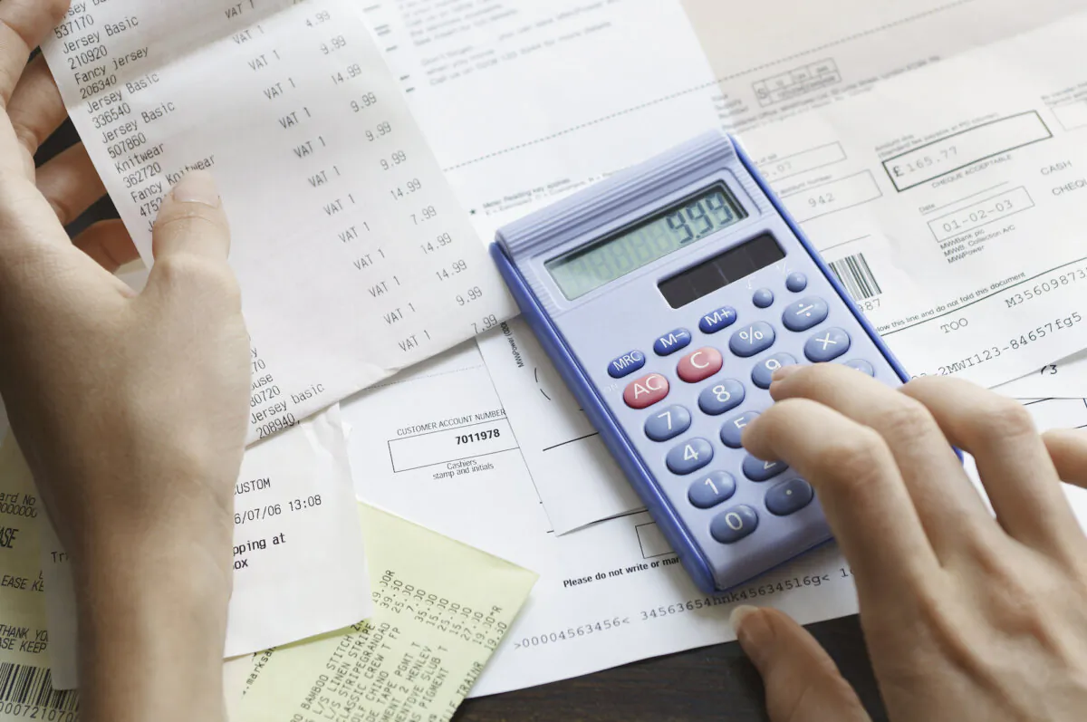 Checking a household budget. (sirtravelalot/Shutterstock)