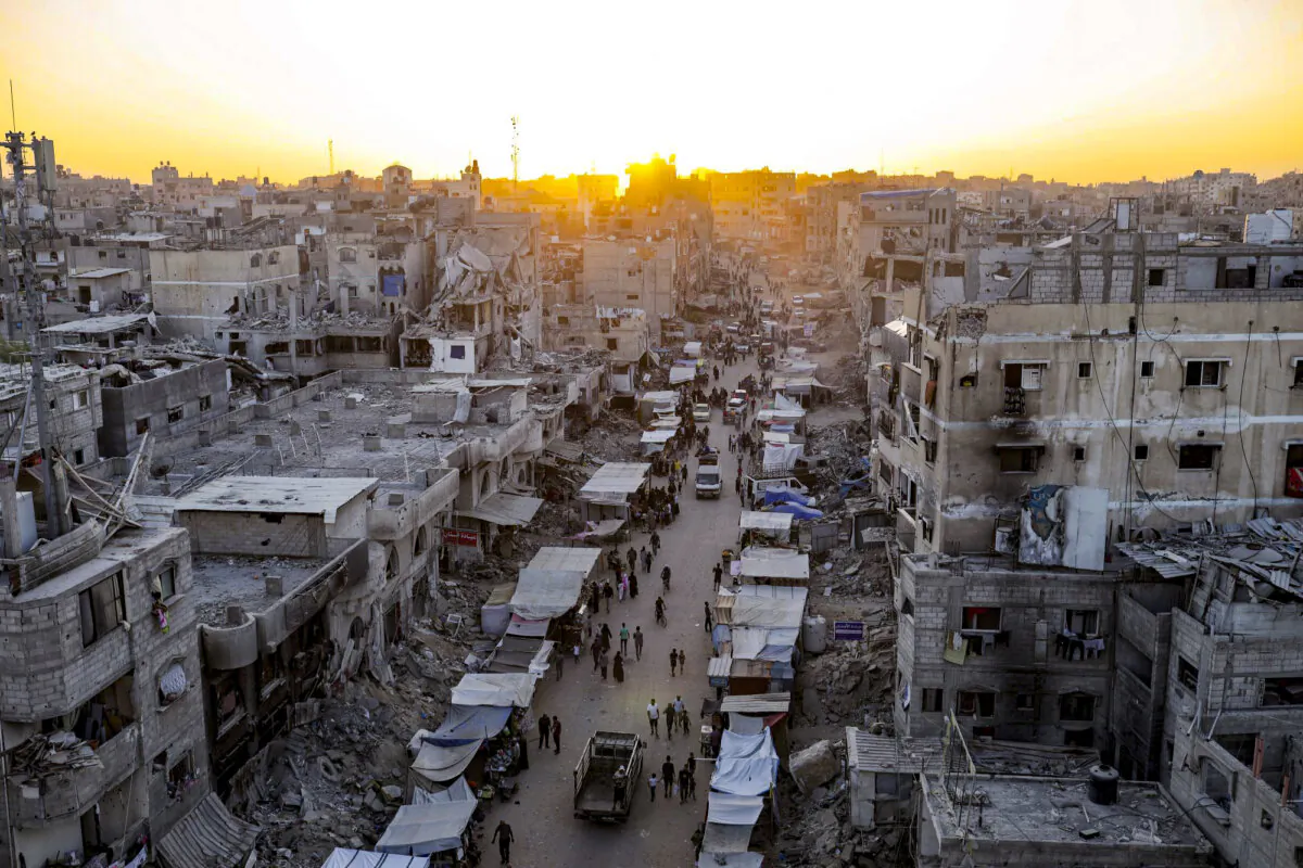 Palestinians displaced by the Israeli bombardment of the Gaza Strip walk through a street market in Khan Younis, southern Gaza Strip, on June 29, 2024. (Jehad Alshrafi/AP Photo)