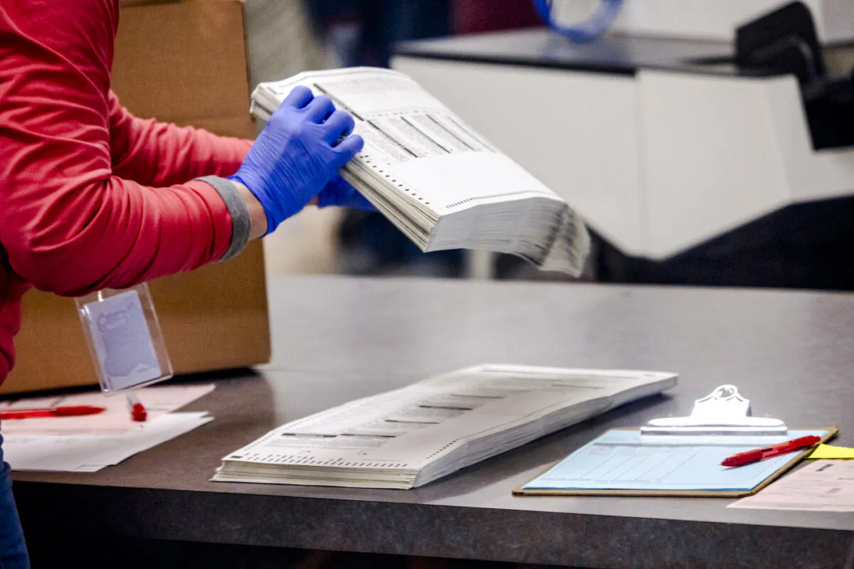 An election worker sorts ballots, in a file photo. (John Moore/Getty Images)