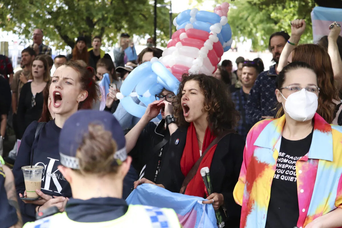 Transgender rights demonstrators are seen during a protest against an event by British activist Kellie-Jay Keen-Minshull at the Tasmanian Parliament House lawns in Hobart, Australia on March 21, 2023. (AAP Image/Ethan James) 