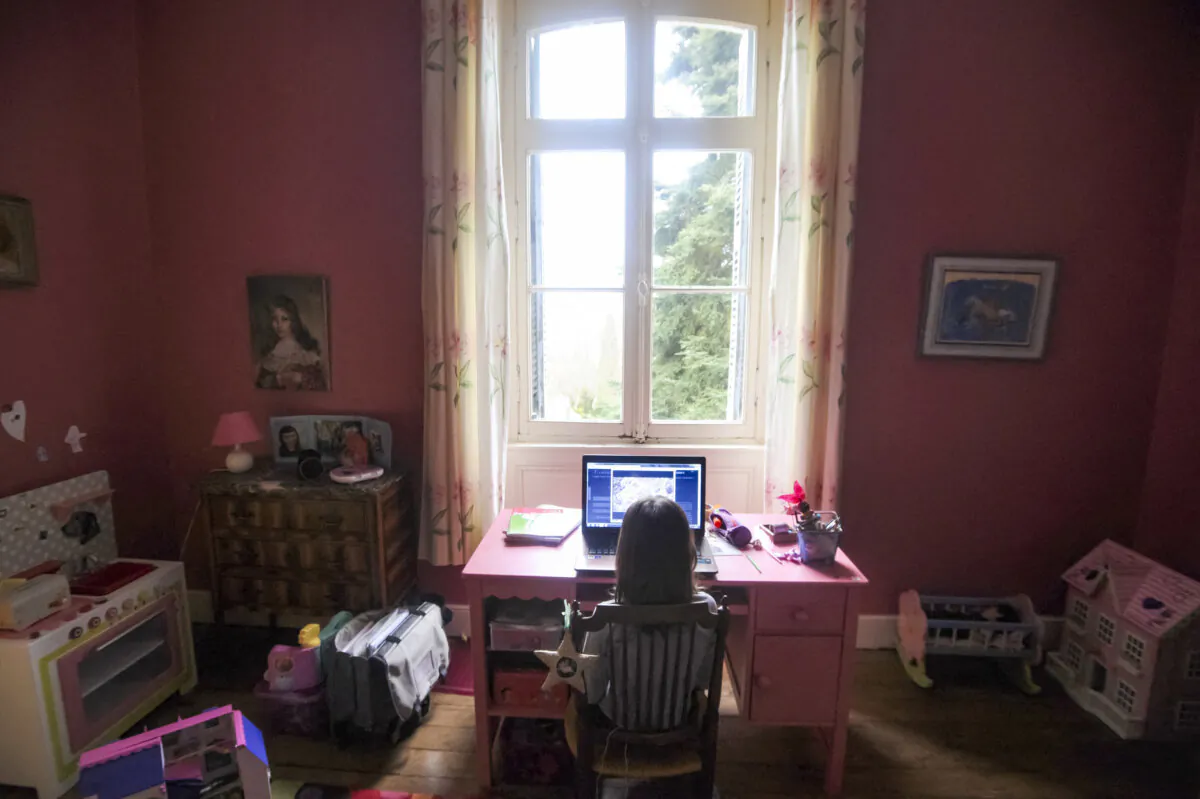 A girl surfs on the web on her computer in Chisseaux, France, in a file photo. (ALAIN JOCARD/AFP via Getty Images)