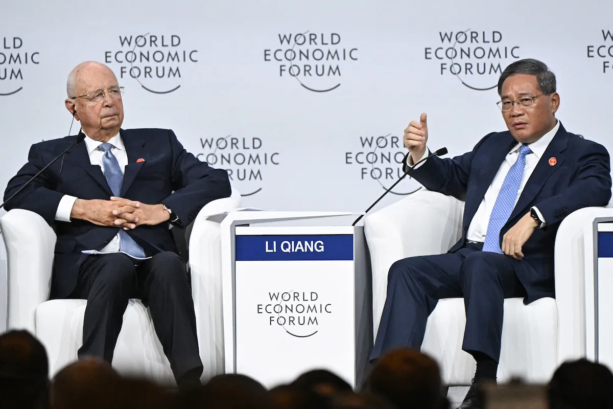 Chinese Premier Li Qiang (R) and World Economic Forum (WEF) Executive Chairman Klaus Schwab attend the opening ceremony of the World Economic Forum Annual Meeting of the New Champions (AMNC24) in Dalian, in China's northeastern Liaoning Province, on June 25, 2024. (Pedro Pardo/AFP via Getty Images)