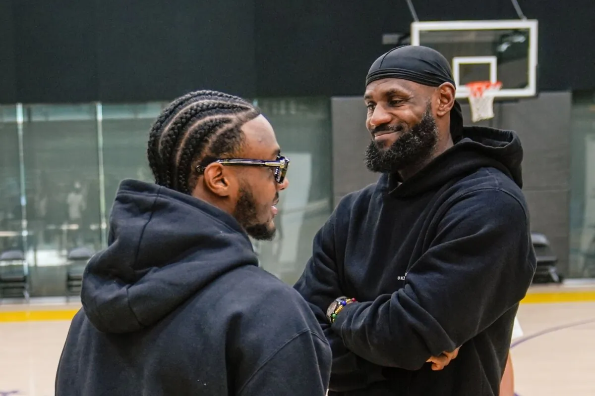 Los Angeles Lakers draft pick Bronny James (L) and his father, LeBron James, share a light moment as they arrive for a news conference in El Segundo, Calif., on July 2, 2024. (Damian Dovarganes/AP Photo)