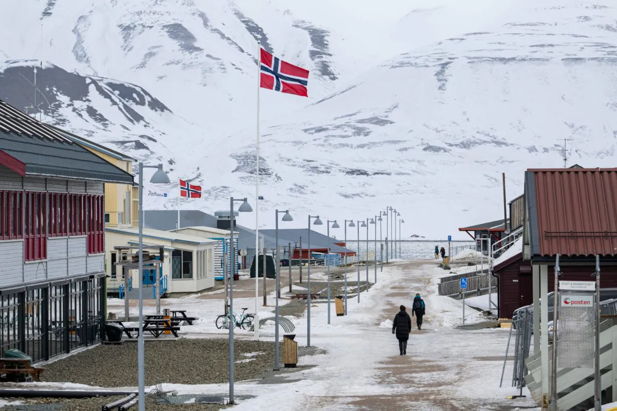 The Norwegian flag flutters on the roadside of Longyearbyen's main street on Spitsbergen island, in Svalbard Archipelago, northern Norway, on May 9, 2022. (Jonathan NACKSTRAND / AFP via Getty Images)
