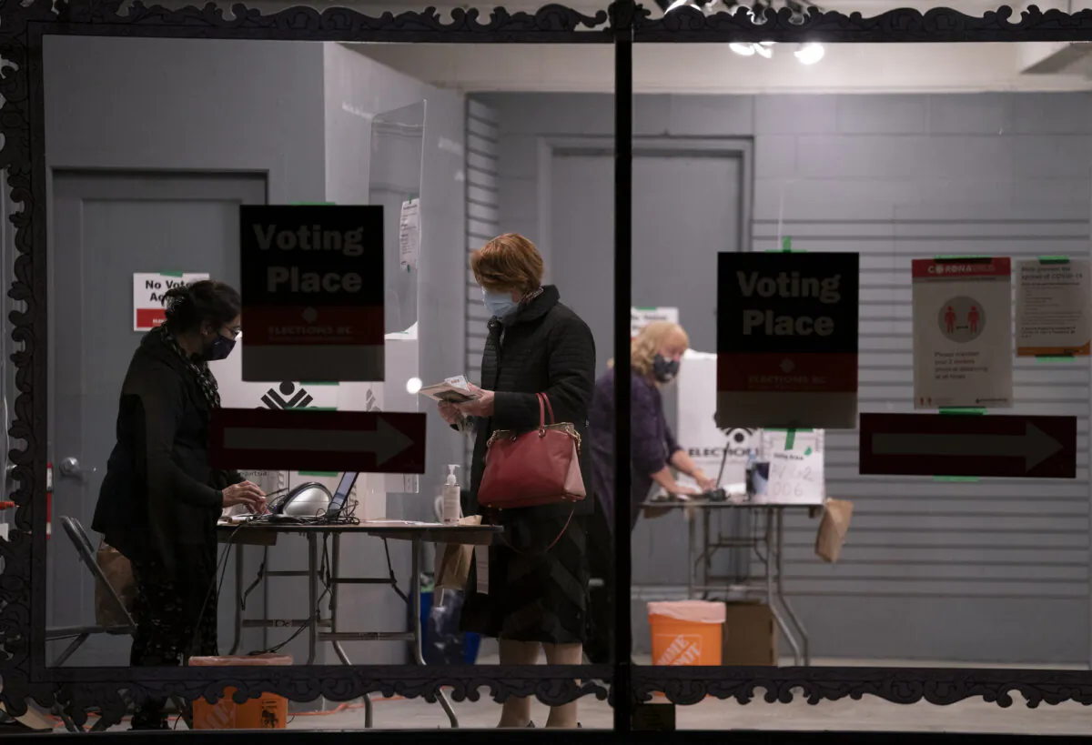 A voter arrives to cast her ballot at an advance polling station in North Vancouver on Oct. 20, 2020. (The Canadian Press/Jonathan Hayward)