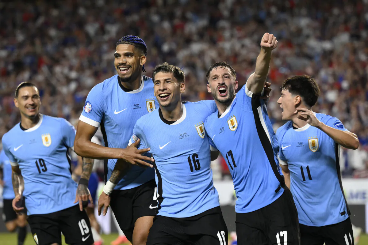 Uruguay's Mathias Olivera (16), celebrates with teammates after scoring his side's opening goal against United States during a Copa America Group C soccer match in Kansas City, Mo., on July 1, 2024. (Reed Hoffman/AP Photo)