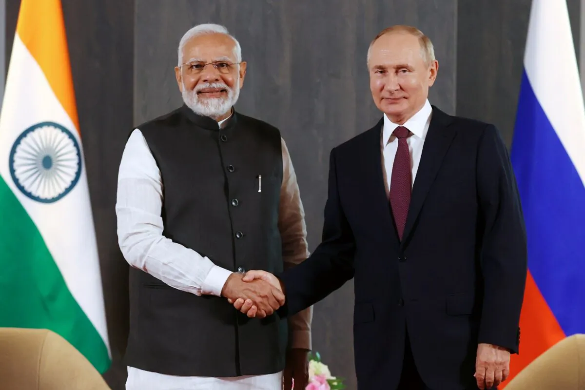 Russian President Vladimir Putin (R) and Indian Prime Minister Narendra Modi pose for a photo shaking hands prior to their talks on the sidelines of the Shanghai Cooperation Organisation (SCO) summit in Samarkand, Uzbekistan, on Sept. 16, 2022. (Alexandr Demyanchuk, Sputnik, Kremlin Pool Photo via AP)