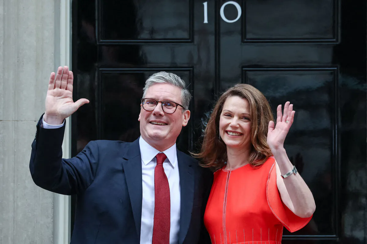 Britain's incoming Prime Minister Keir Starmer and his wife Victoria wave as they pose on the steps of 10 Downing Street in London on July 5, 2024. (Justin Tallis/AFP via Getty Images)