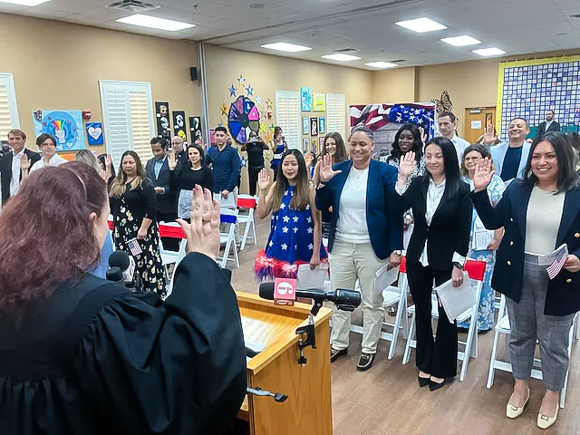 Middle District of Florida Magistrate Judge Leslie Hoffman Price administers the citizen’s oath to 20 new Americans during a naturalization ceremony at Hope CommUnity Center in Apopka, Florida, on July 4, 2024. (Epoch Times/John Haughey)