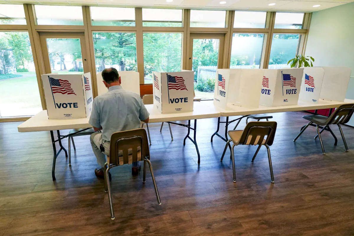 A voter sits at a poll kiosk at a Mississippi Second Congressional District Primary election precinct, in Jackson, Miss., on June 7, 2022. (Rogelio V. Solis/AP Photo)