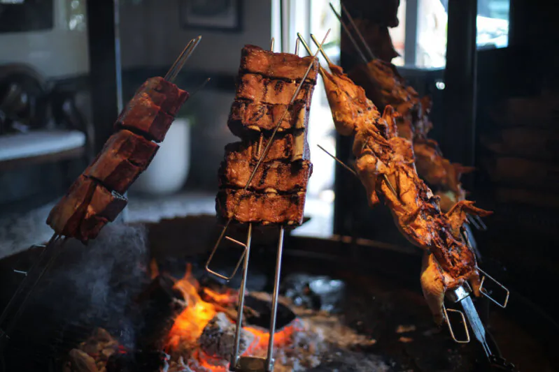 Meat over the fire at Graziano's restaurant in Miami, Fla. (Courtesy of the Graziano family)