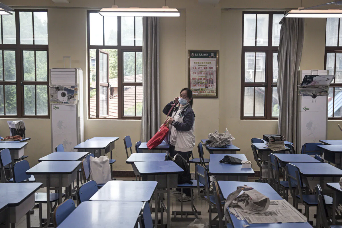 A senior student carries books while moving to a new classroom in Wuhan, Hubei Province, China, on May 6, 2020. (Getty Images)